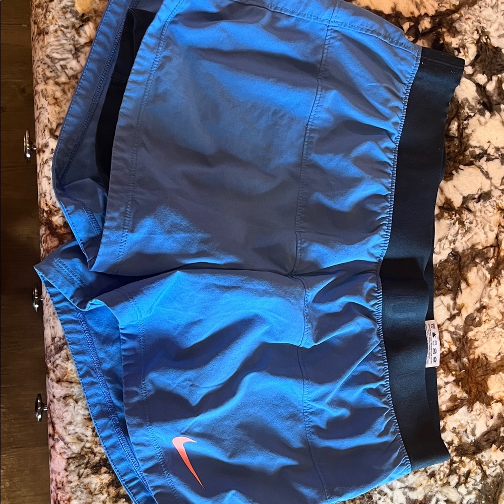 Nike Blue Athletic Shorts with Black Waistband and Coral Swoosh